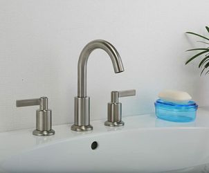 FAUCET... BRAND NEW, STILL IN THE BOX, BRUSH NICKEK FAUCET WITH MODERN POP-UP SINK STOPPER
