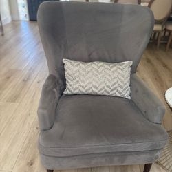 Two gray wingback chairs