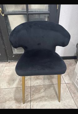 Black suede chair with metal gold legs