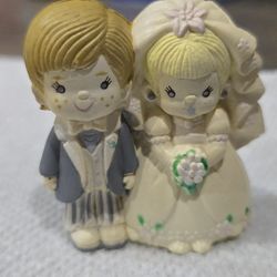 Vintage Precious Moments-style bride and groom wedding cake topper figurine. 