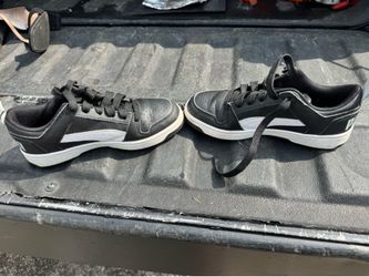 Puma Rebound Joy Low Top sneakers in black and white. Size 3
