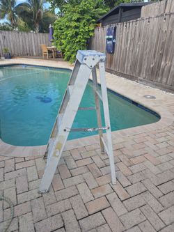 yellow fiberglass step ladder.