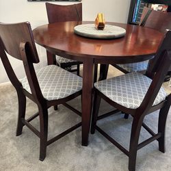 Round table with four bar height chairs