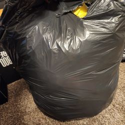 Trash bag full of coats/jackets & snow pants kids and adults