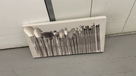 canvas wall art piece featuring chic makeup brushes