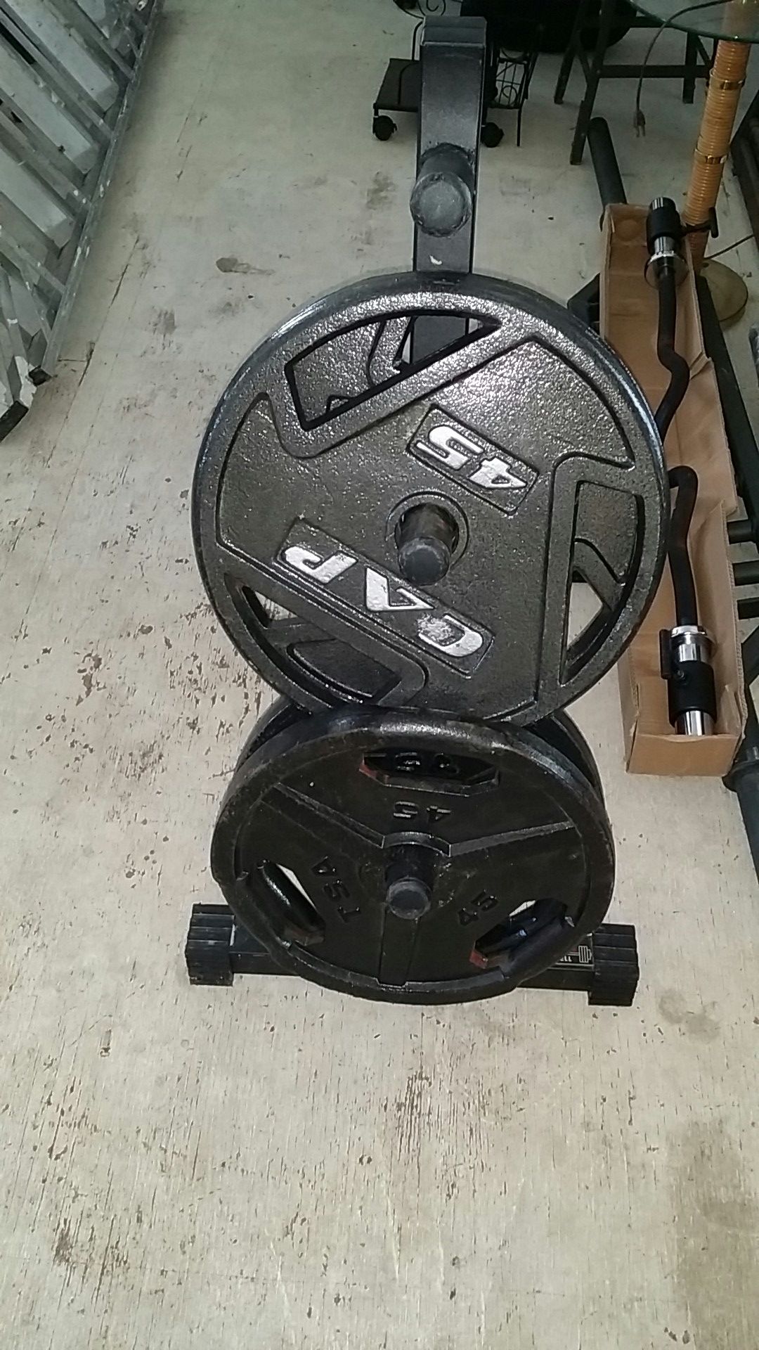 Four 45 pound olympic plates plus weight tree