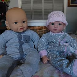 2 large size baby dolls with bag of clothes