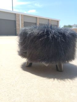Black fuzzy footstool