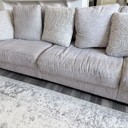 Large light gray L-shaped sectional sofa.