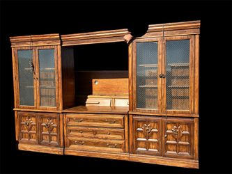 wood entertainment center or hutch with glass-paneled doors and lower cabinets.