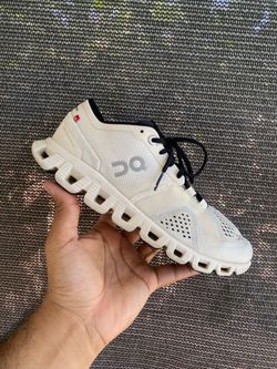 On Cloud X running shoes in white and black.