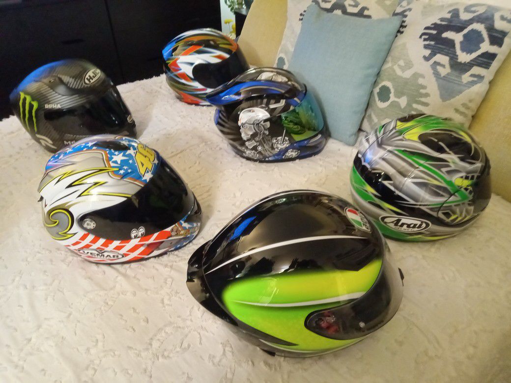 A collection of motorcycle racing helmets All extra large