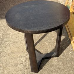 modern dark wood round side or end table featuring a distinctive geometric, V-shaped pedestal base