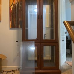 Glass Cabinet Three Shelves With A Light In It,