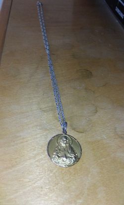 Real silver chain with a real 14k gold Jesus emblem
