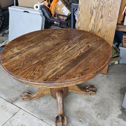 Solid wood table with claw feet expansion leaf.