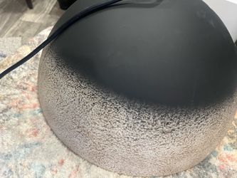 it’s metal, black tan and gold brand new never used Hanging light.