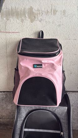 This is a pink, PetAmi carrier for small animals.