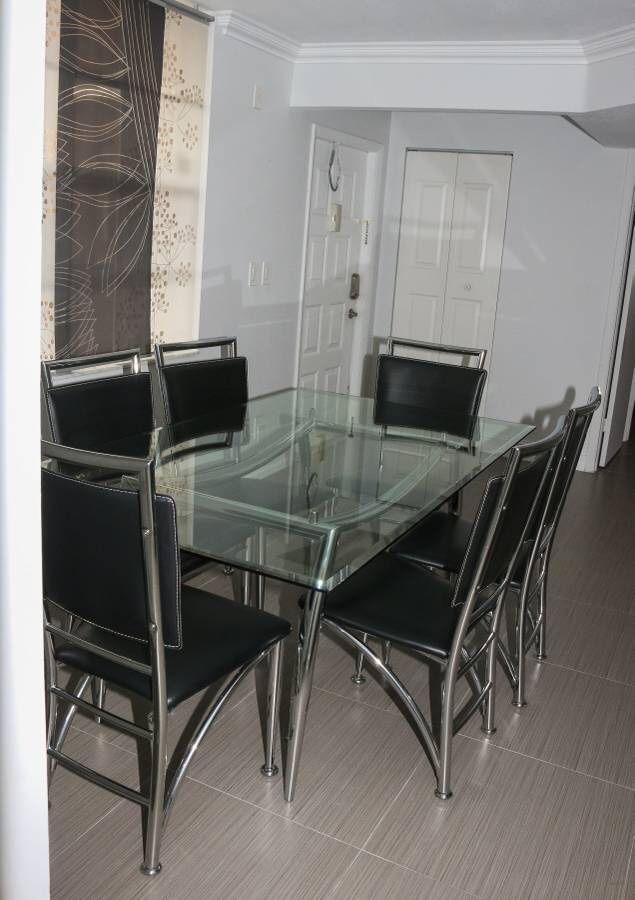 Modern Glass Dining room table with 6 black and chrome chairs