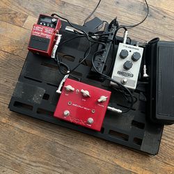 Pedal board with pedals.