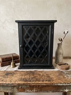Beautiful, rustic wall-mounted or standing black cabinet.