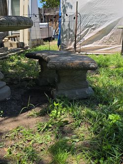 This item is a vintage concrete garden table with matching curved benches.