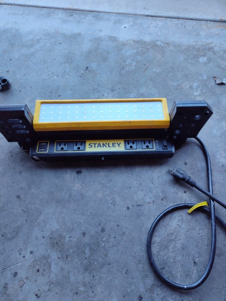 It's A Stanley 1000 Lumens Portable Work Bench Shop Light with AC and 2.1 Amp USB Power Strip Charging Ports