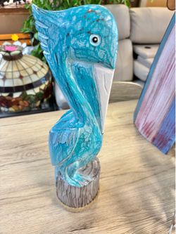New handcrafted carved pelican on post