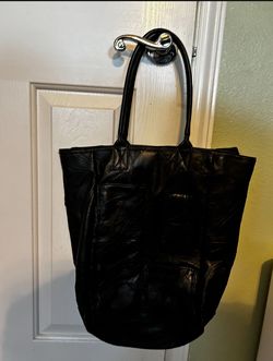 Large Black Purse NEW has three outer pockets one pocket inside closes with zipper