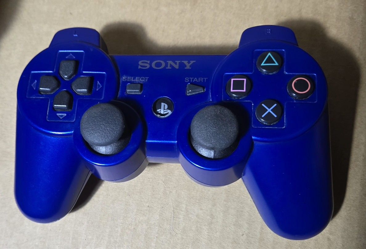 Blue DualShock 3 Sixaxis ControllerBlack Sony PlayStation DualShock 3 Sixaxis controller.
