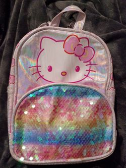 Sanrio Hello Kitty Mini Backpack Featuring a Holographic scale pattern body. Rainbow striped Sequin Pocket