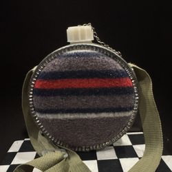 Vintage wool blanket-covered metal canteen