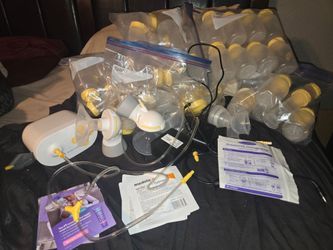 Medela Pump In Style with MaxFlow Double Electric Breast Pump set along with a large collection of matching storage bottles and accessories