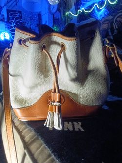 This vintage Dooney & Bourke white and bown draw string purse