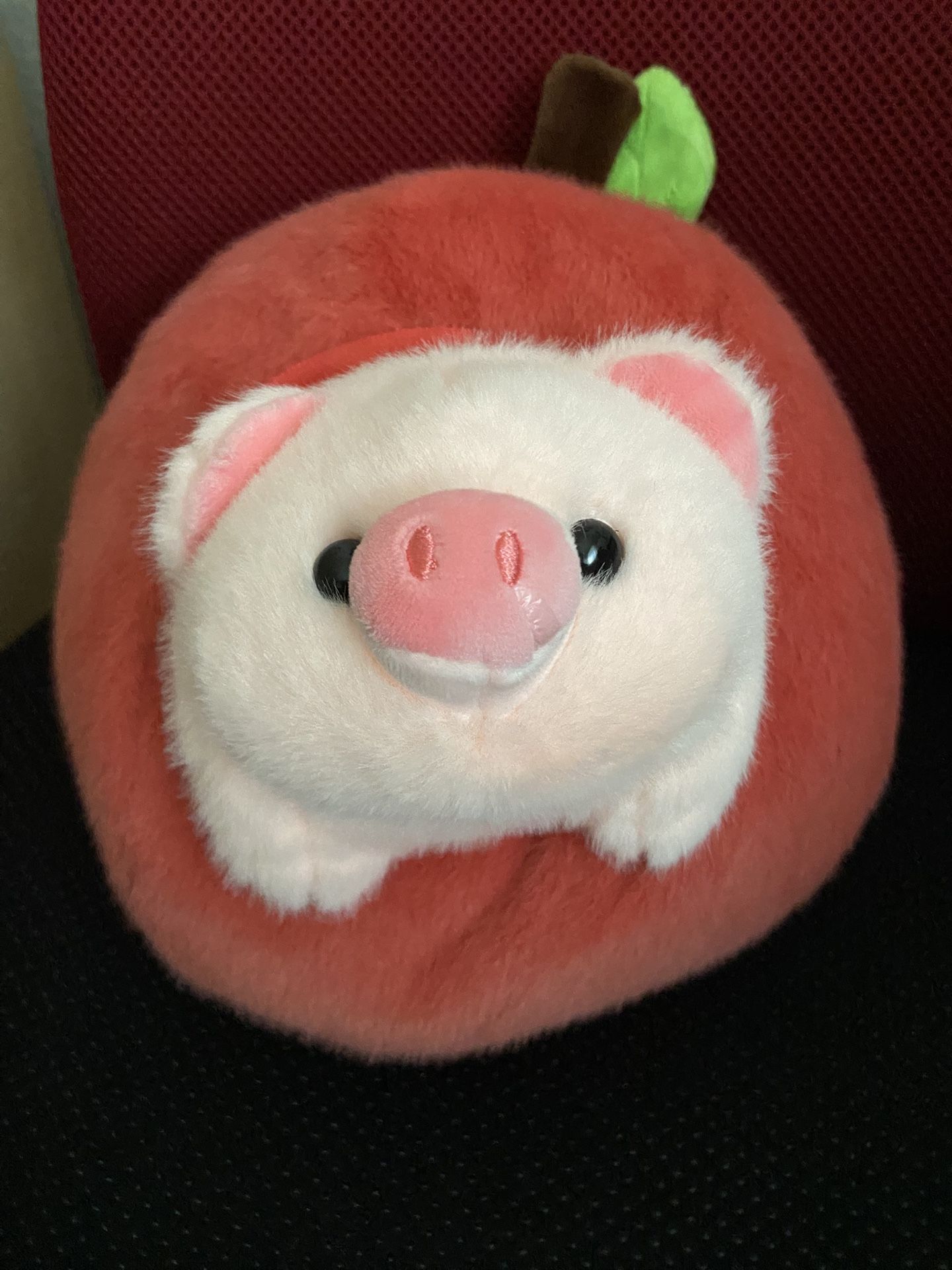 piggy stuffed animal with an apple plush toy