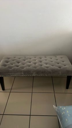 Grey tufted bench