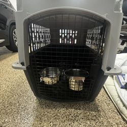 Pet kennel with food and water bowl