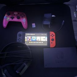 Nintendo Switch with neon red and gray controllers
