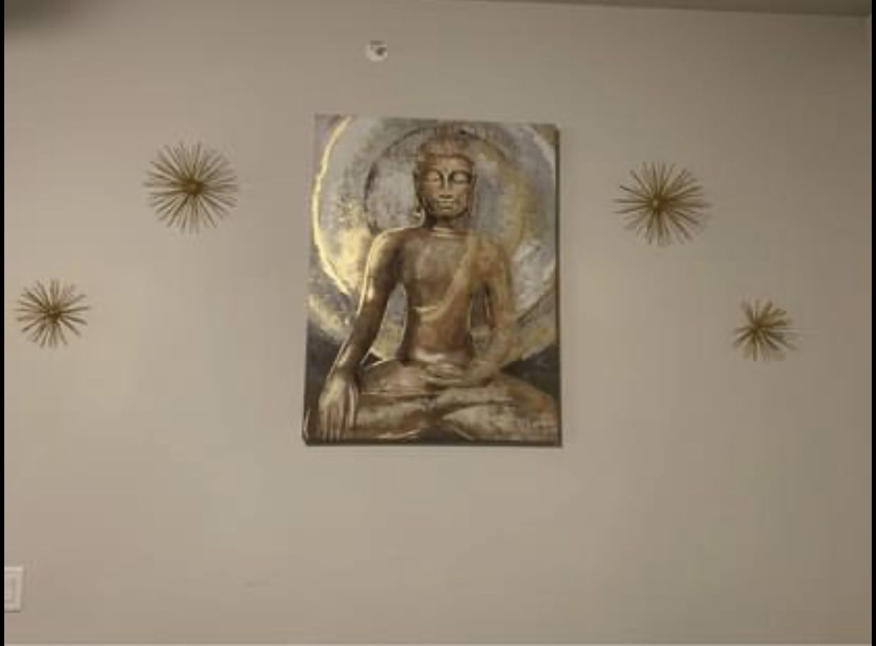 Metallic Buddha and gold metal star bursts