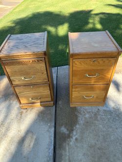 Two light wooden filling cabinets.