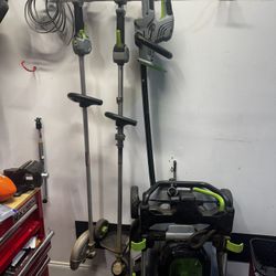 EGO Battery Powered Lawn Mower, Trimmer, Weed Eater, and Edger.   Comes with 2 batteries and charger