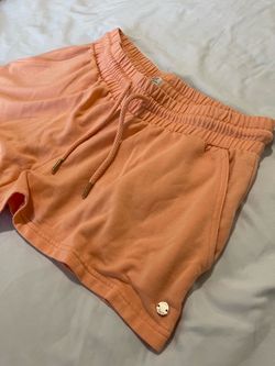 ROXY lounge sweat shorts in a peach or cantaloupe shade