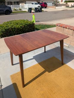 Midcentury dining table with hidden extendable leaf