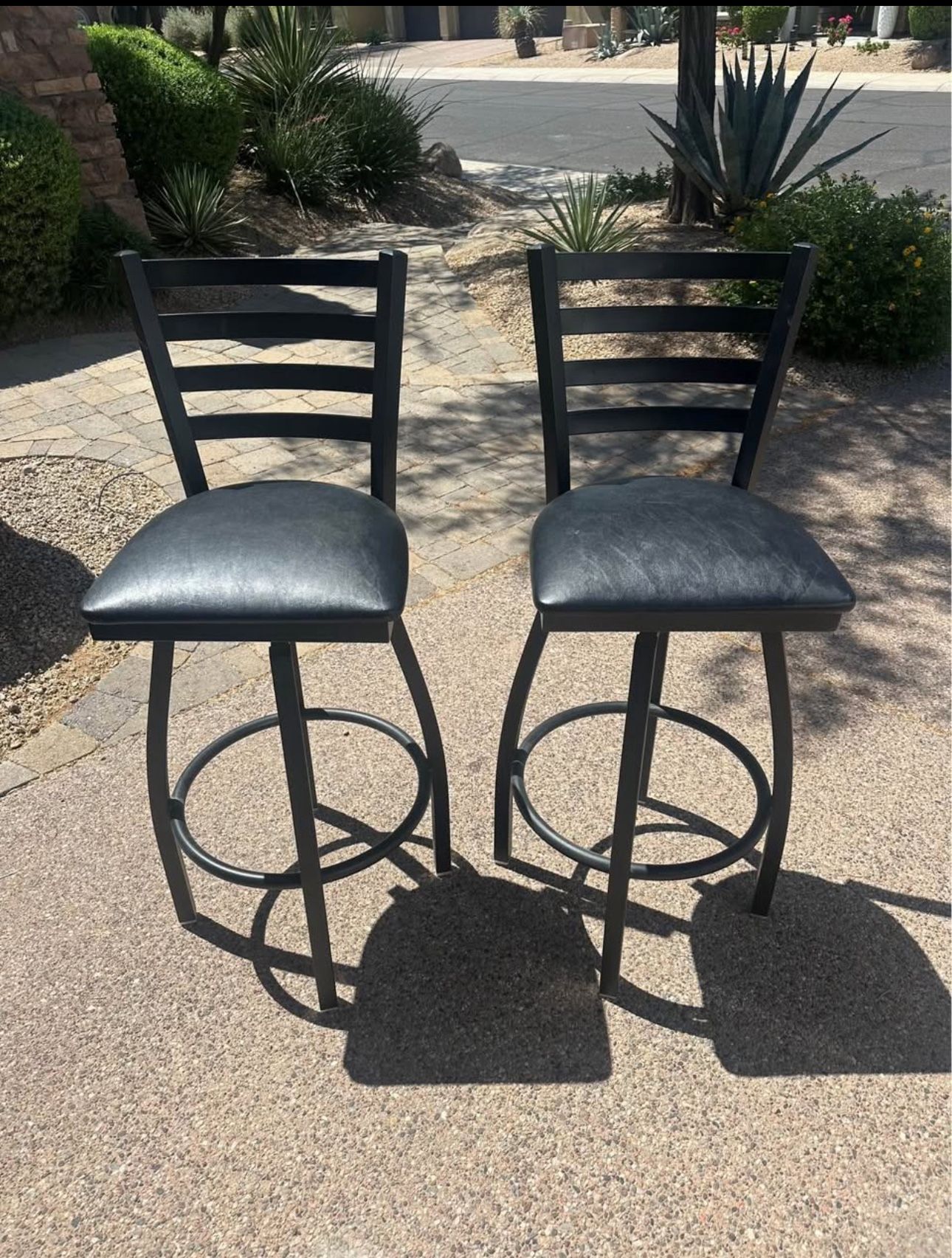 A Set Of Black Bar Height Swival Stools