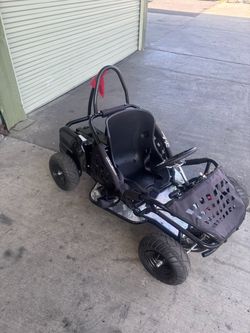Awesome Go-Bowen go-kart. Black frame with a comfy seat. Has seatbelt for safety. Metal diamond plate footrests. Red safety flag on the back. Tires lo