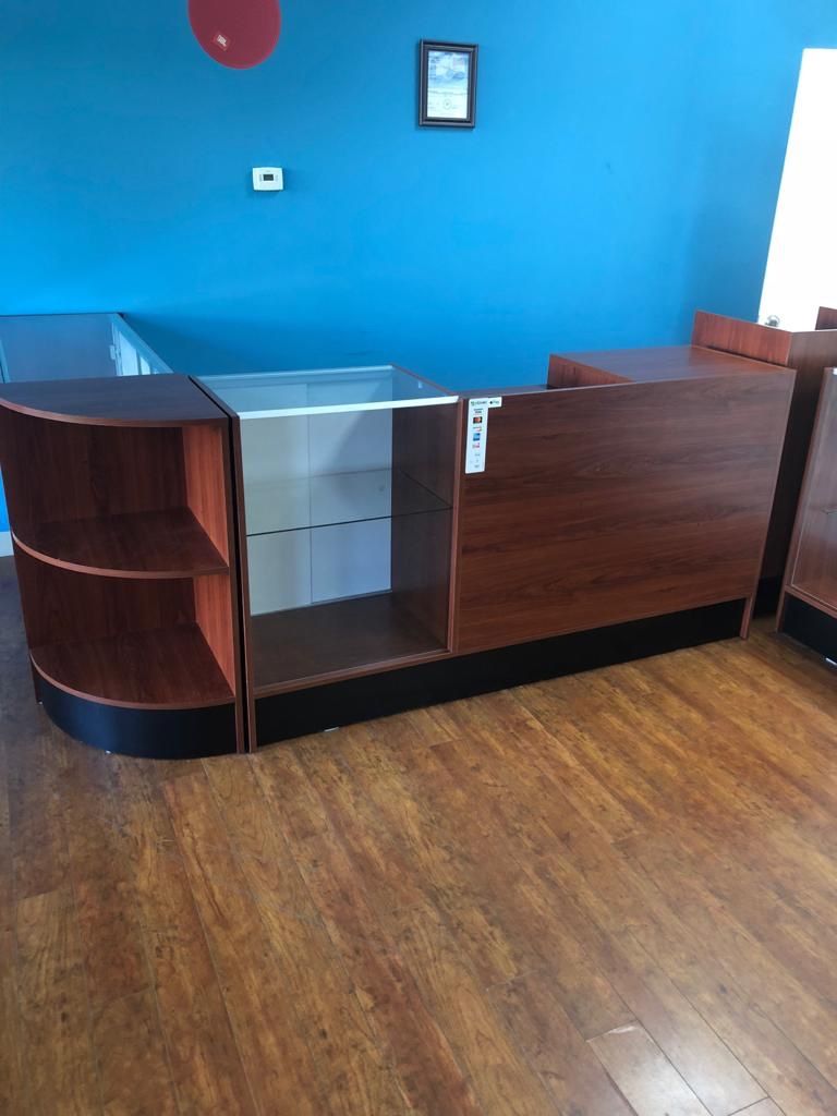 Retail counter w/cherry finish, adjustable tempered glass shelves & sliding doors