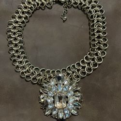 This is a choker-type necklace with a floral statement pendant adorned with rhinestones, from The Limited$35
