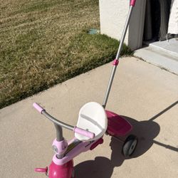 Selling a SmarTrike kids tricycle with push handle.