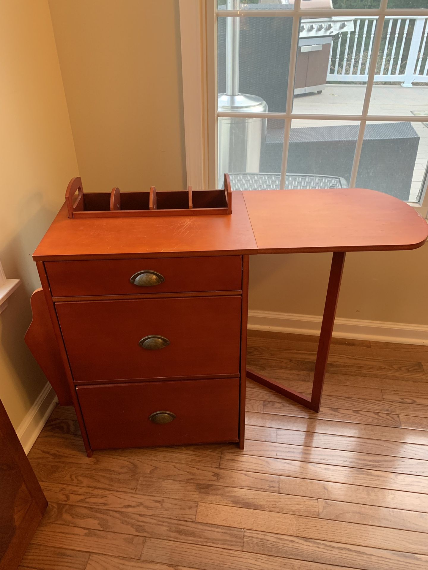 Mobile filing cabinet with small work shelf.