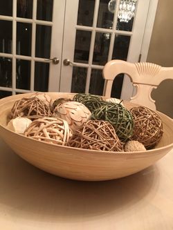 Offwhite decorative bowl with multiple wicker and some twine decorative balls.18”diameter and 6” high